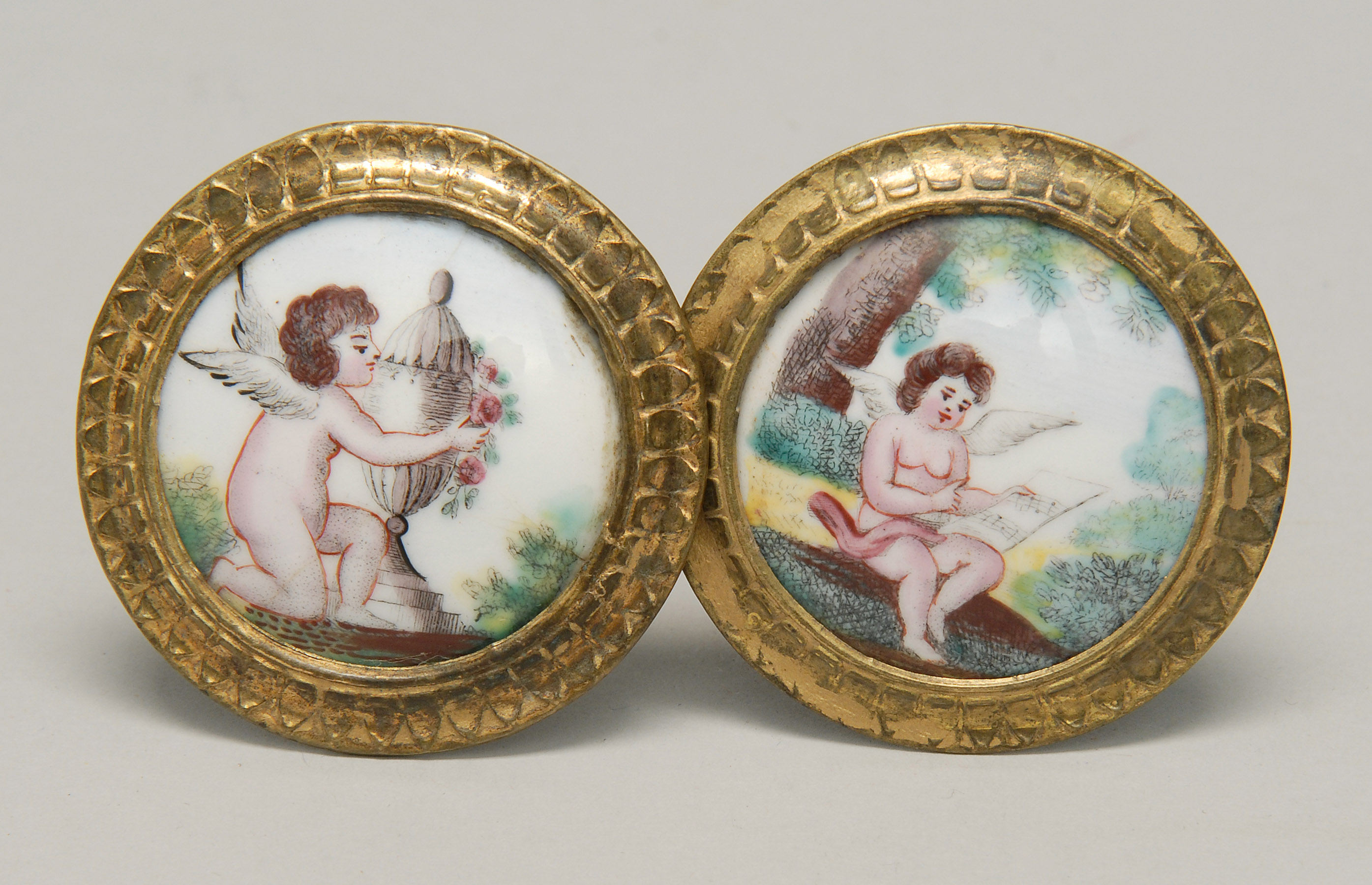 Appraisal: PAIR OF BATTERSEA-BILSTON ENAMEL TIE-BACKS th Early th CenturyBoth with