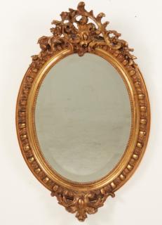 Appraisal: PETITE FRENCH CARVED GILTWOOD AND GESSO OVAL MIRROR WITH BEVEL