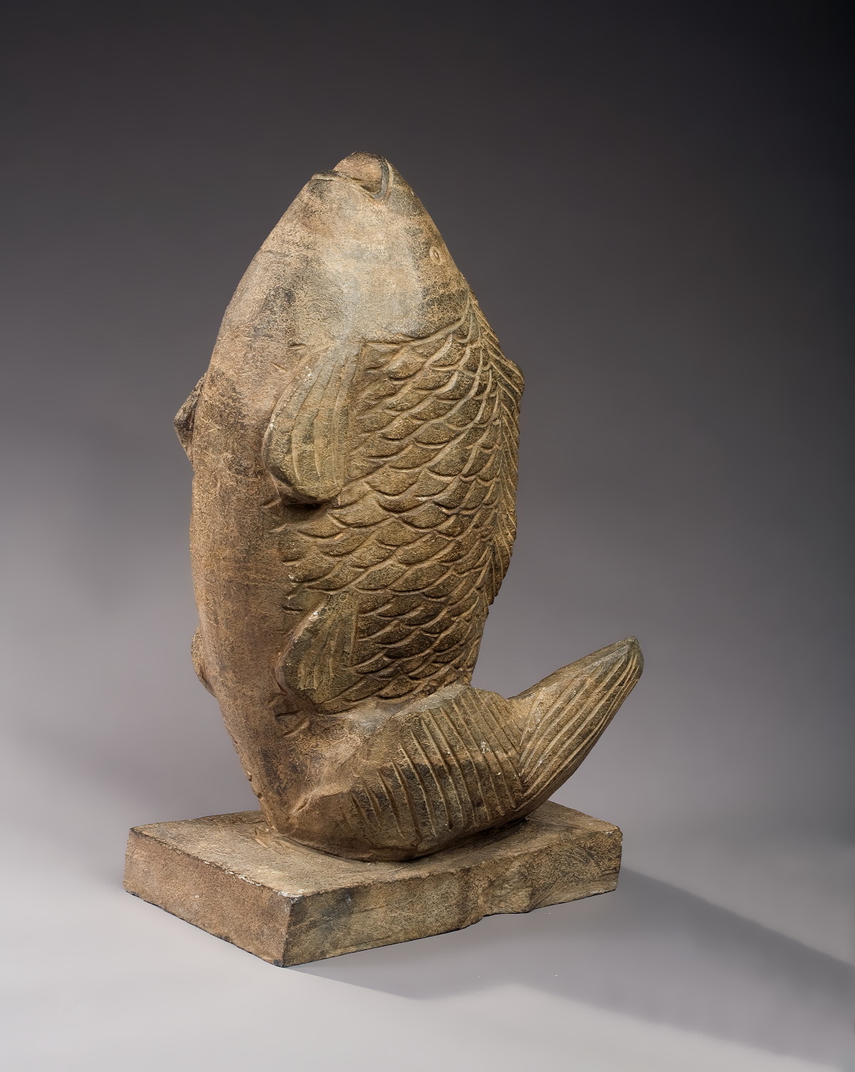 Appraisal: CARVED STONE FIGURE OF A LEAPING FISH ON A PLINTH