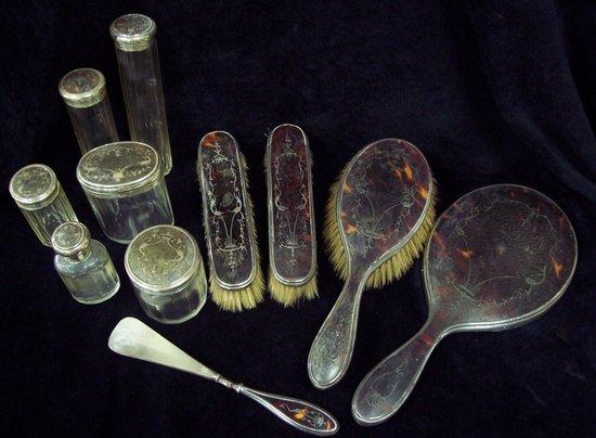 Appraisal: A tortoiseshell and silver backed dressing table set of eleven