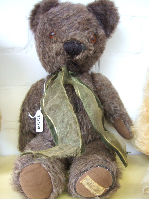 Appraisal: A Merrythought teddy bear with brown fur orange glass eyes