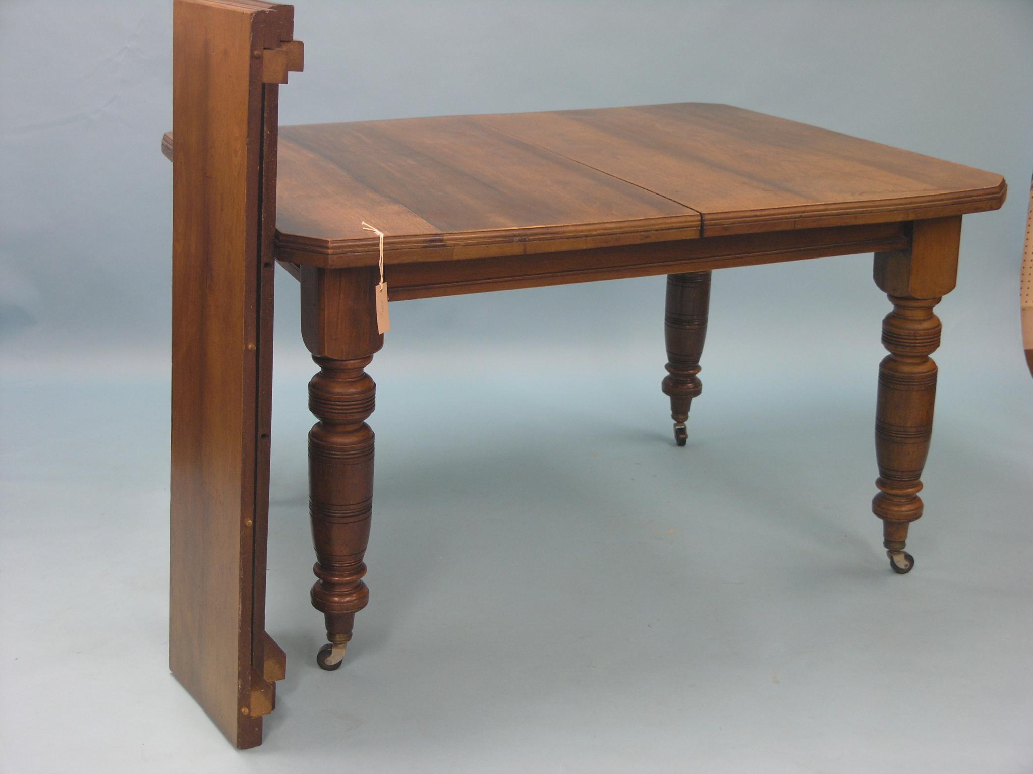 Appraisal: A Victorian walnut dining table wind-action with two extra leaves