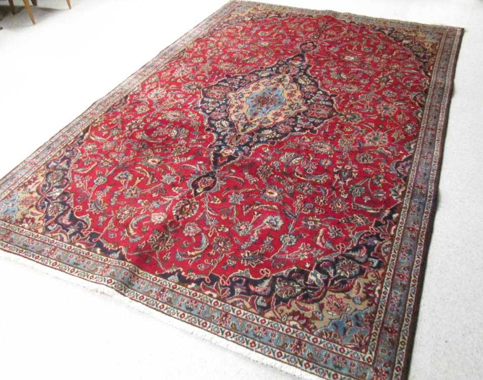 Appraisal: SEMI-ANTIQUE PERSIAN CARPET floral and central floral medallion design on