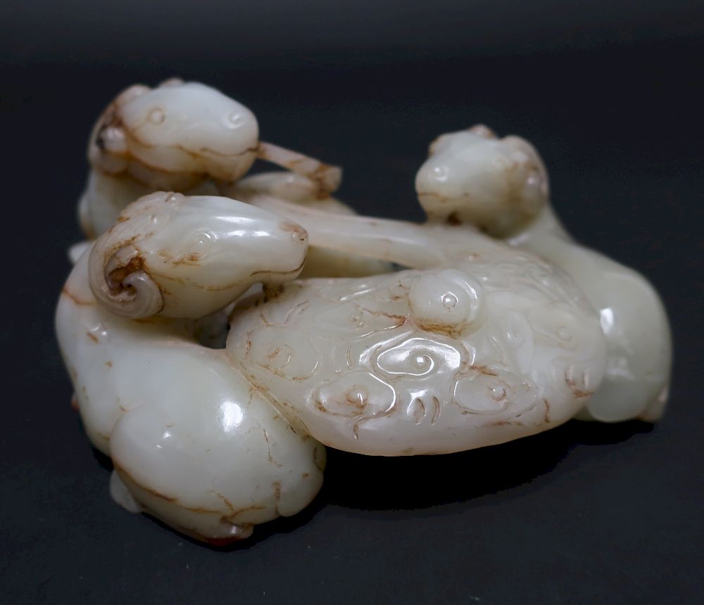 Appraisal: Chinese White Celadon Jade Group In the form of recumbent