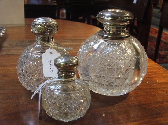 Appraisal: A COLLECTION OF THREE SILVER TOPPED GLASS SCENT BOTTLES varying