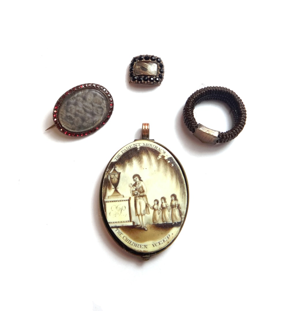 Appraisal: A group of mourning jewellery comprising an oval glazed pendant