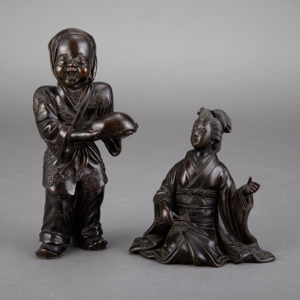 Appraisal: Two Japanese Bronze Figures Of a happy boy holding a