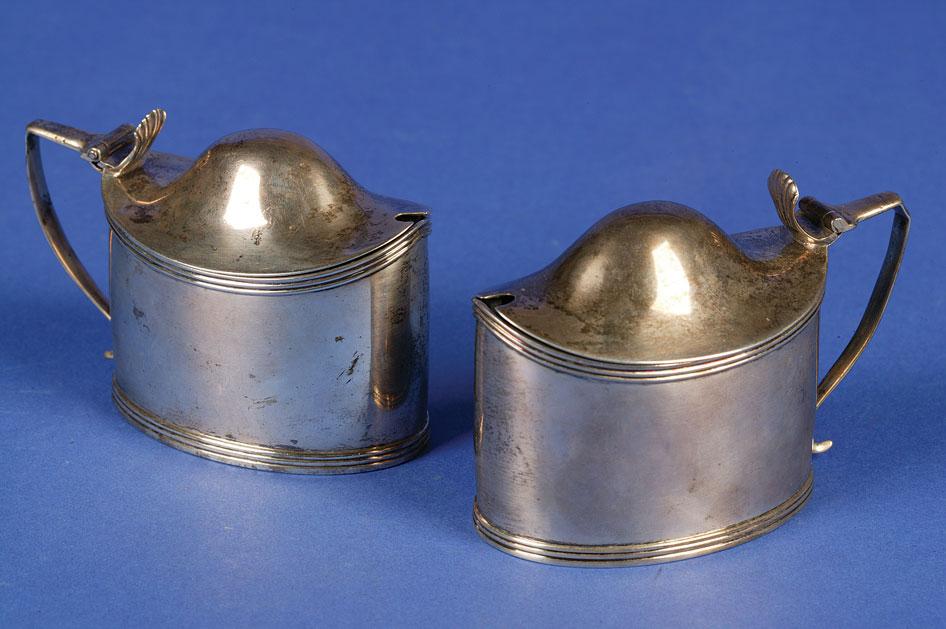 Appraisal: A PAIR OF GEORGE III MUSTARD POTS of oval form