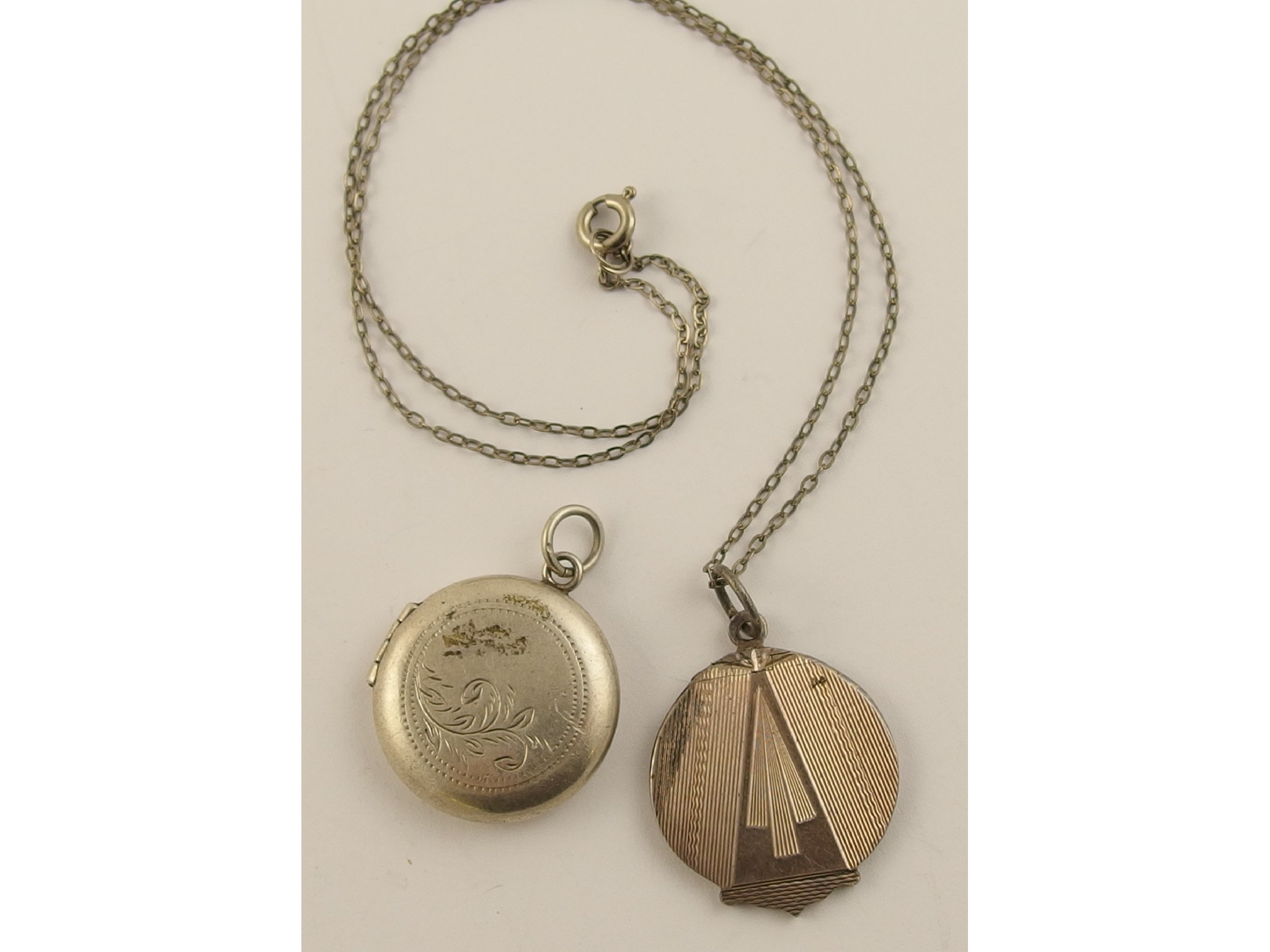 Appraisal: A silver Art Deco machine engraved locket and a further