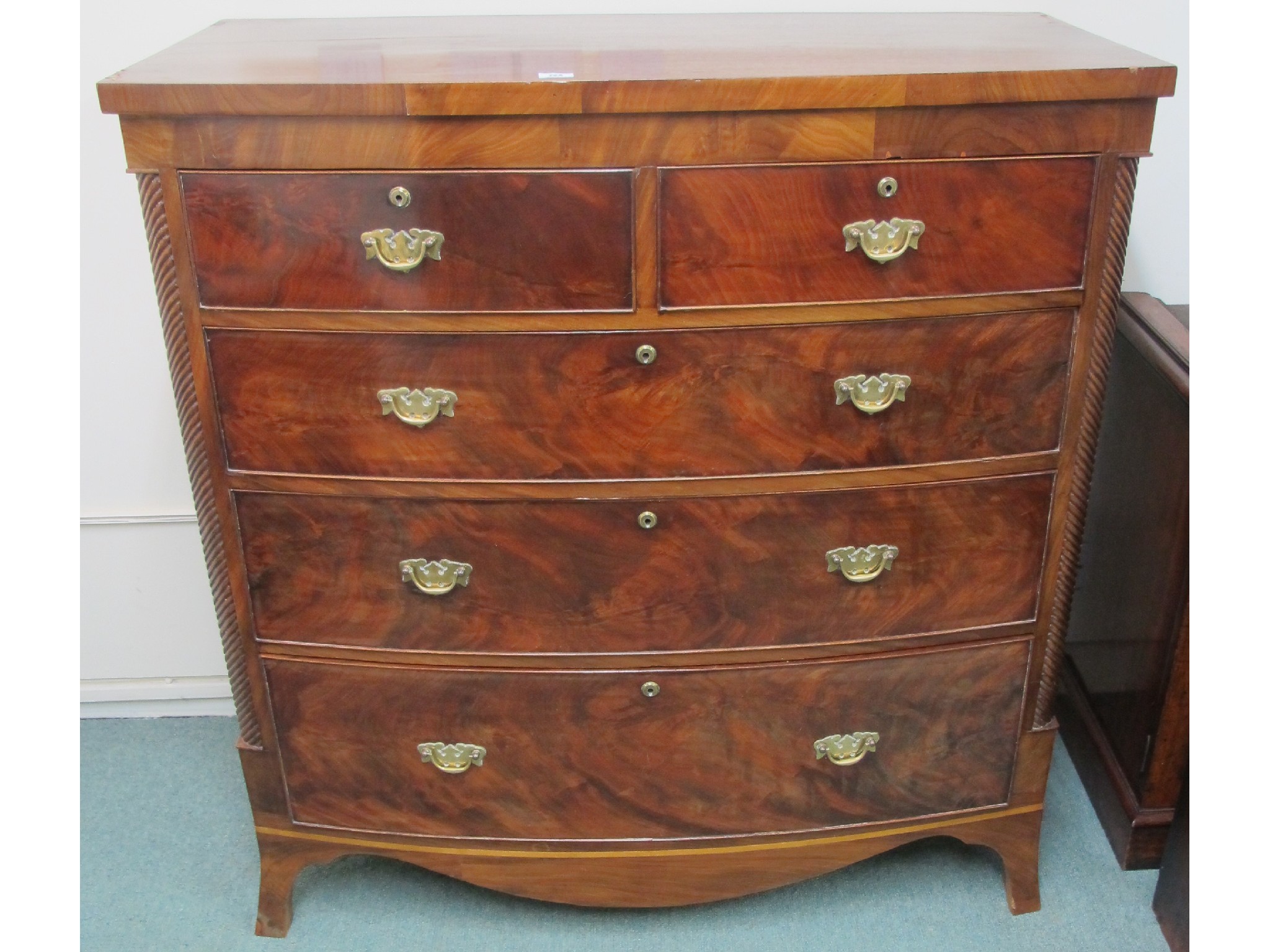 Appraisal: A Victorian mahogany two over three bow fronted chest with