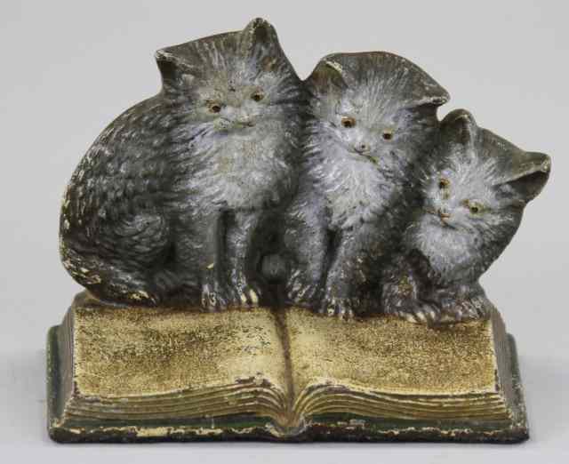 Appraisal: THREE KITTENS ON BOOK Marked Bradley Hubbard finely cast detail