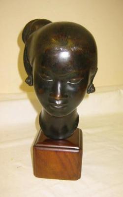 Appraisal: A JAPANESE BRONZE BUST modelled as a girls head her