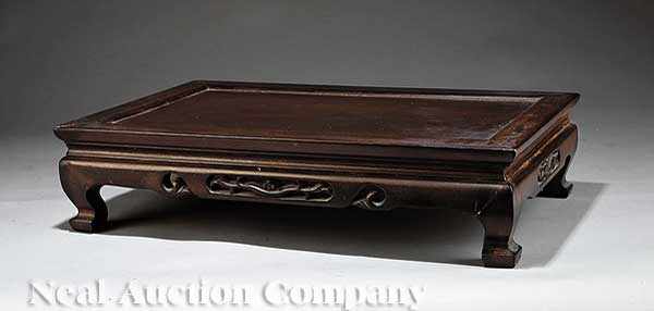 Appraisal: A Chinese Carved Hardwood Rectangular Stand molded top pierced apron