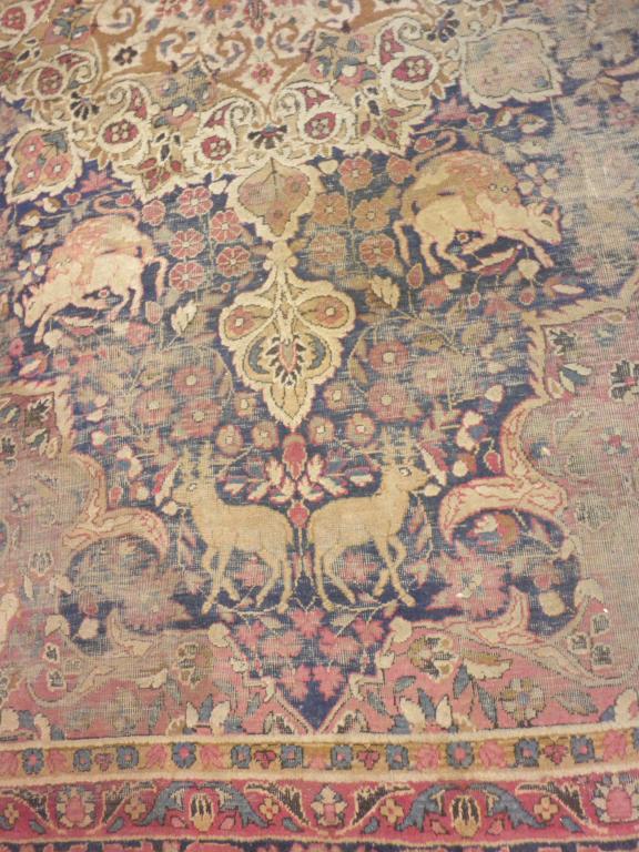 Appraisal: A Persian pictorial carpet with a central medallion surrounded by