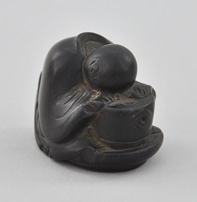 Appraisal: A Carved Wood Netsuke of a Sleeping Person Carved boxwood