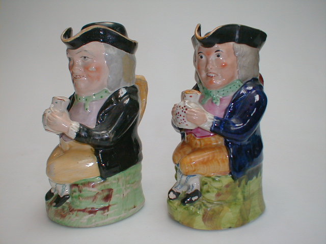 Appraisal: Two Staffordshire Toby Jugs depicting The Squire with an ale