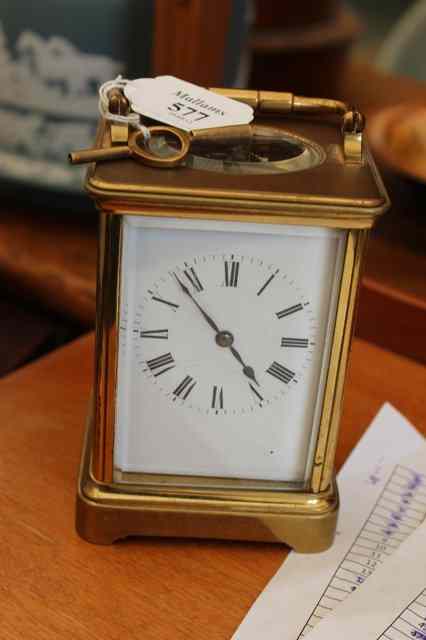 Appraisal: A FRENCH BRASS CARRIAGE TIMEPIECE with carrying handle white enamel