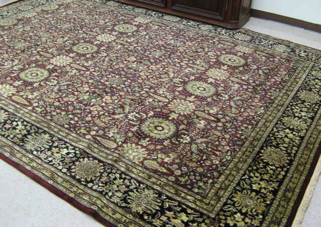 Appraisal: HAND KNOTTED ORIENTAL CARPET Indo-Persian overall floral design on burgundy