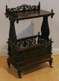 Appraisal: A Victorian rosewood whatnot with a Canterbury base featuring fretwork