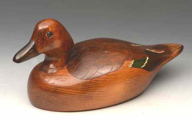 Appraisal: A CARVED AND STAINED WOODEN DECOY DUCK signed to the