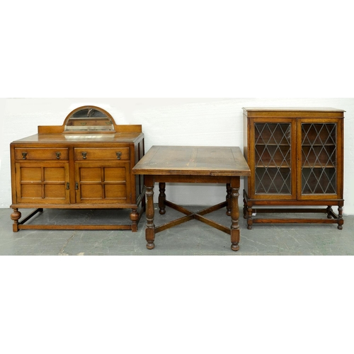 Appraisal: A walnut bookcase with leaded glass doors an oak dining