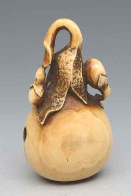 Appraisal: A JAPANESE IVORY NETSUKE in the form of a Nasubi