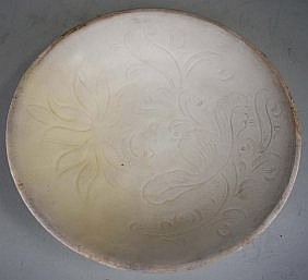 Appraisal: CHINESE WHITE GLAZED EARTHENWARE DISHThe slip decorated gently flared dish