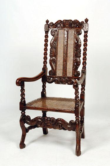 Appraisal: A CHARLES II STAINED BEECH AND CANE-WORK ARMCHAIR the tall