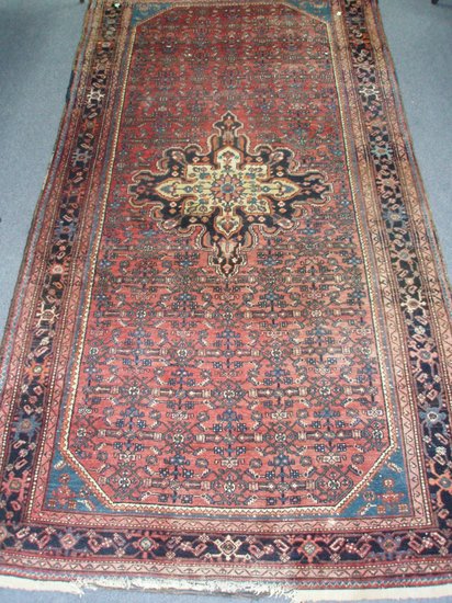 Appraisal: An Eastern rug bordered and figured and of puce ground