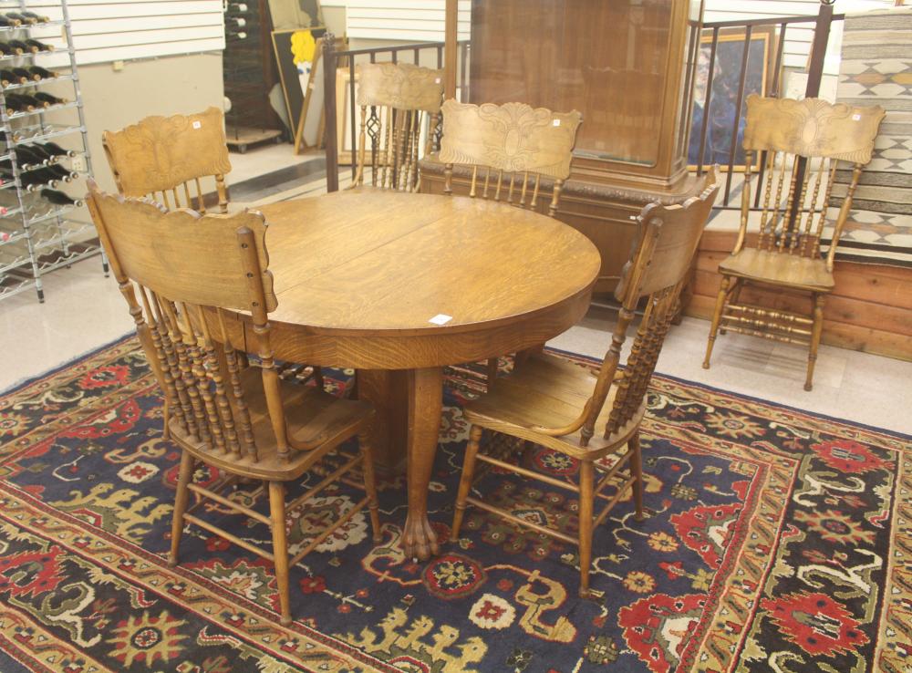 Appraisal: ROUND OAK DINING TABLE SIX CHAIRS THREE LEAVES GROUP American