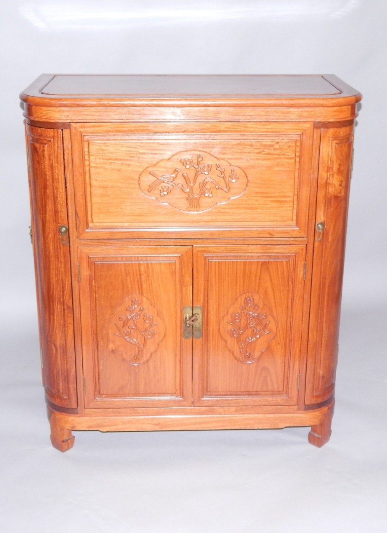 Appraisal: A Chinese bow fronted hardwood cocktail cabinet the hinged top