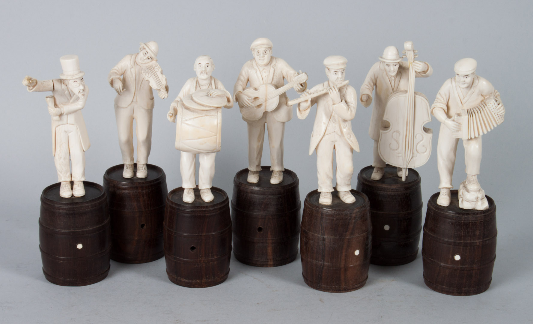 Appraisal: Seven Continental carved ivory musicians each carved and ink highlighted