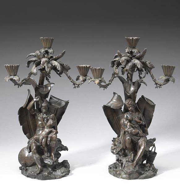 Appraisal: A pair of English patinated bronze three light figural candelabra