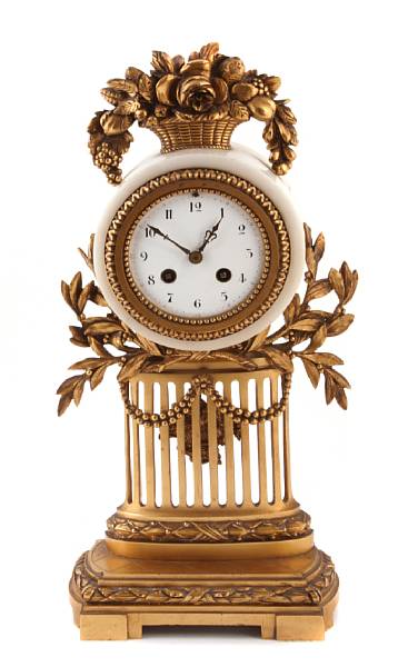 Appraisal: A Louis XVI style gilt metal and marble mantel clock