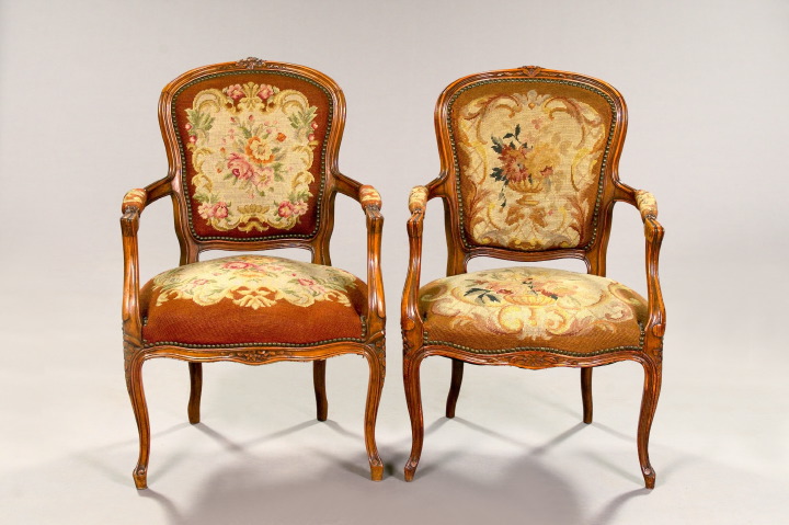 Appraisal: Near-Pair of Louis XV-Style Carved Fruitwood and Needlepoint Fauteuils early