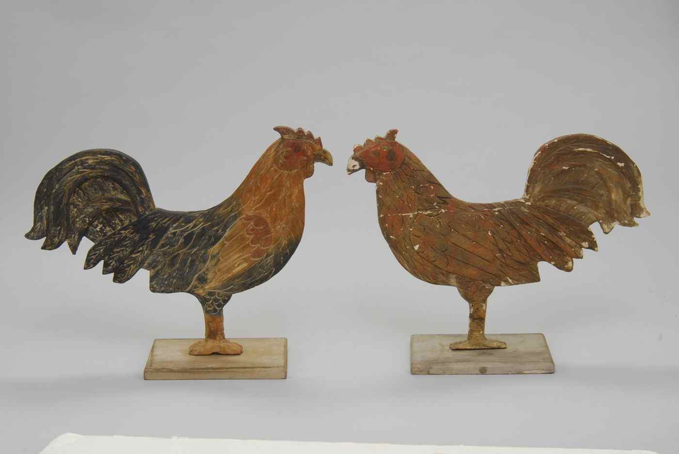 Appraisal: TWO CARVED AND PAINTED WOODEN FOLK ART ROOSTERS th CenturyIn