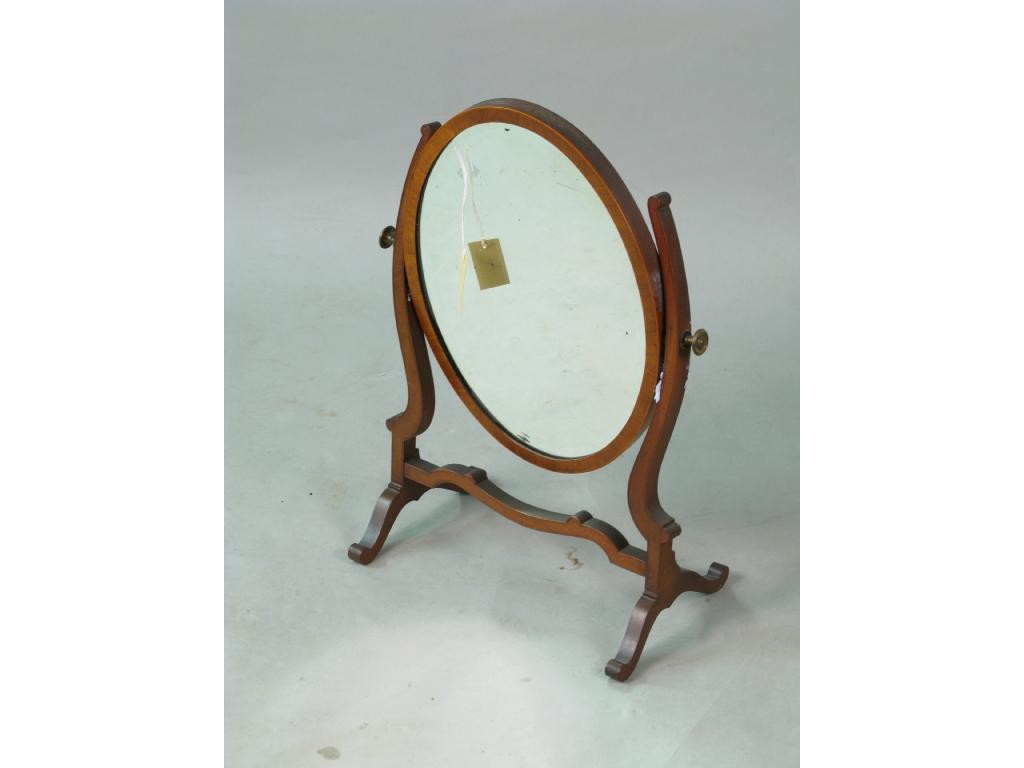 Appraisal: A reproduction mahogany toilet mirror oval plate on shaped stand