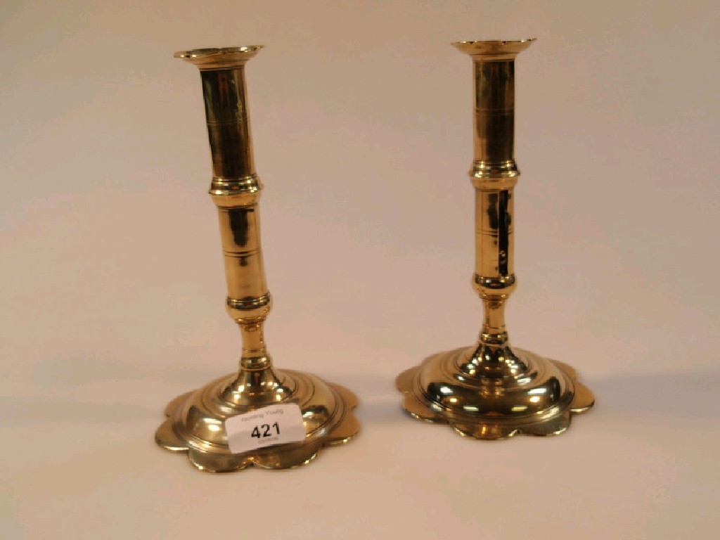 Appraisal: A pair of early thC brass candlesticks with circular knopped