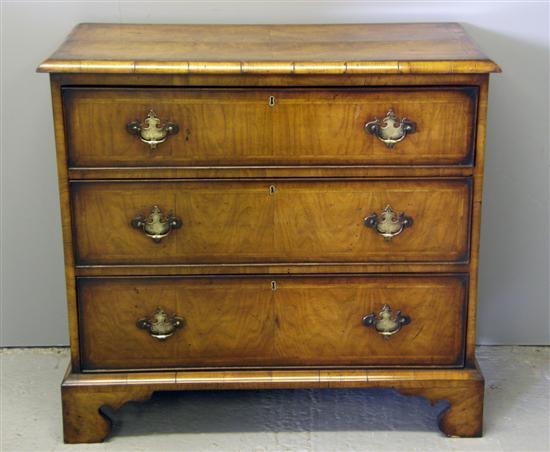 Appraisal: th century style walnut chest of three long drawers on