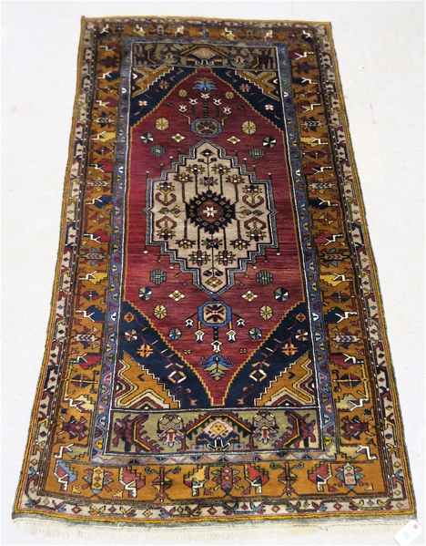 Appraisal: PERSIAN BELOUCH AREA RUG central geometric medallion and stylized floral