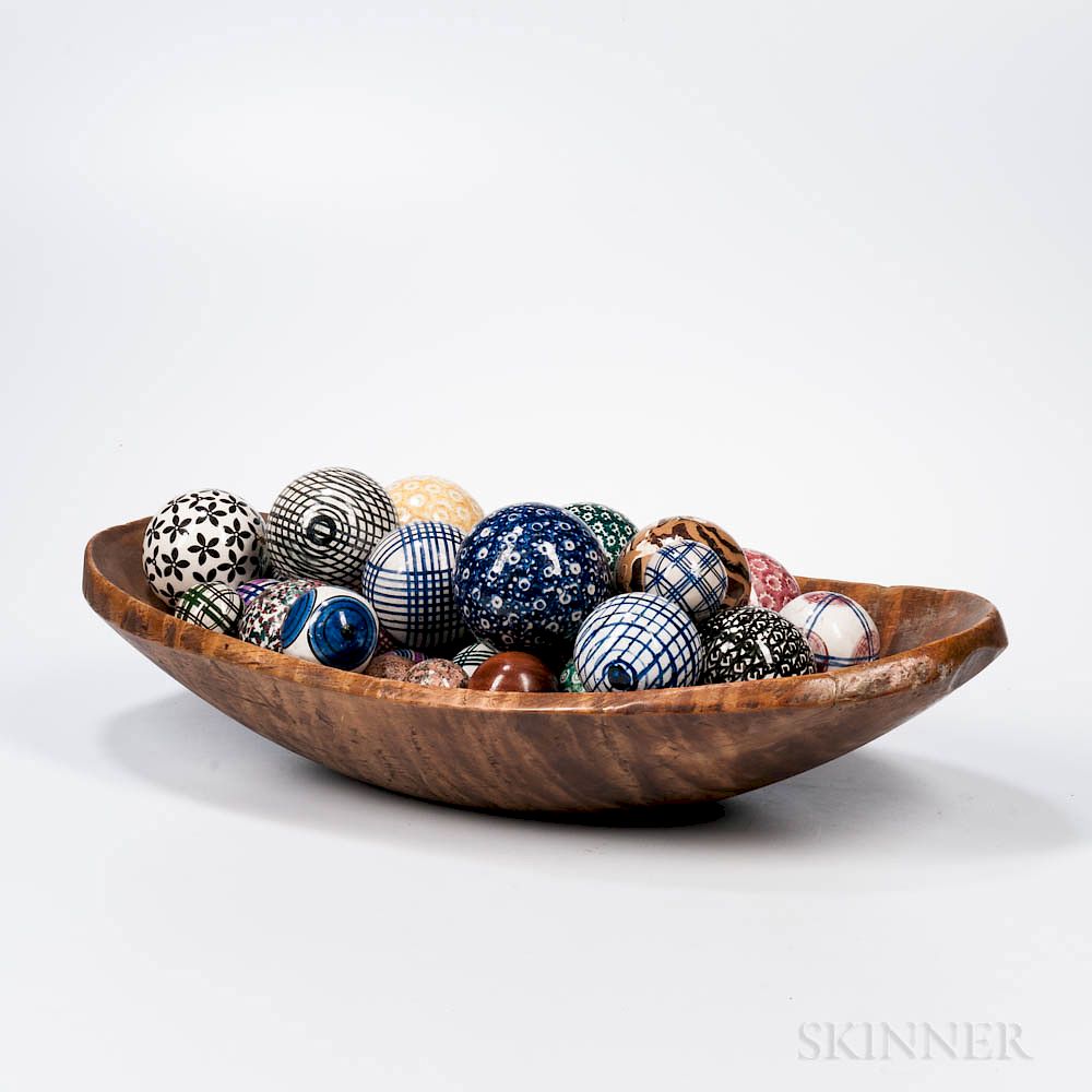 Appraisal: Carved Tiger Maple Oval Chopping Bowl and Thirty Carpet Balls