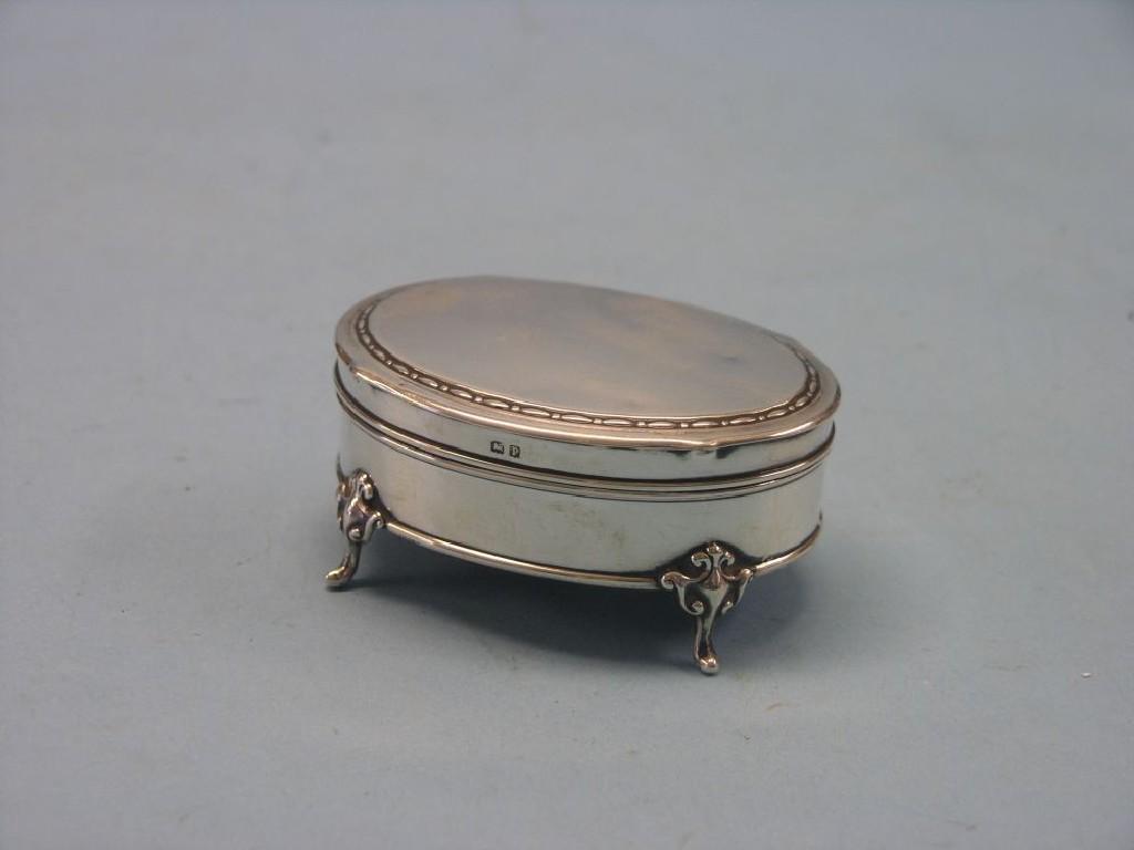 Appraisal: A silver jewellery box oval-shape with lined interior on scroll