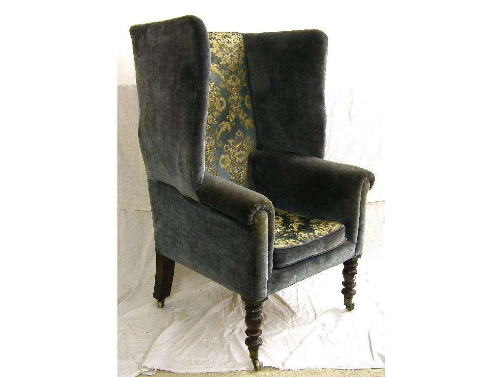 Appraisal: Georgian wing armchair with blue floral upholstery upon turned front