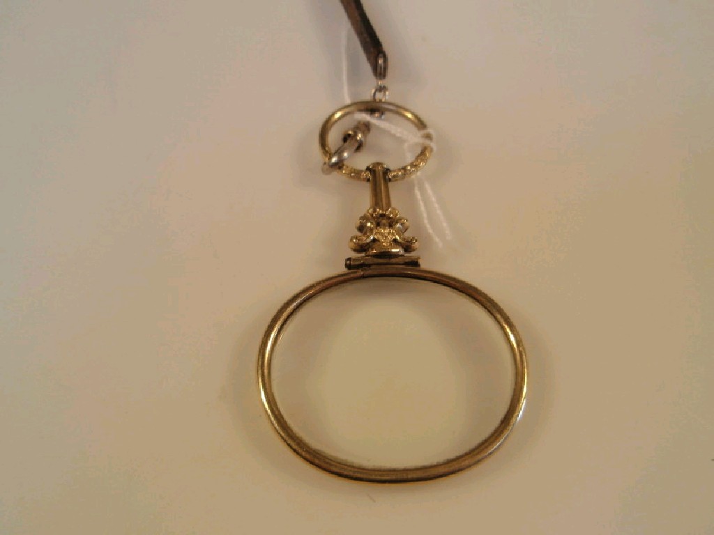 Appraisal: An oval small magnifying glass set in yellow metal