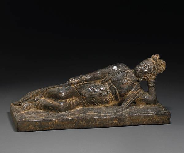 Appraisal: A black stone figure of Guanyin Shown in a reclining