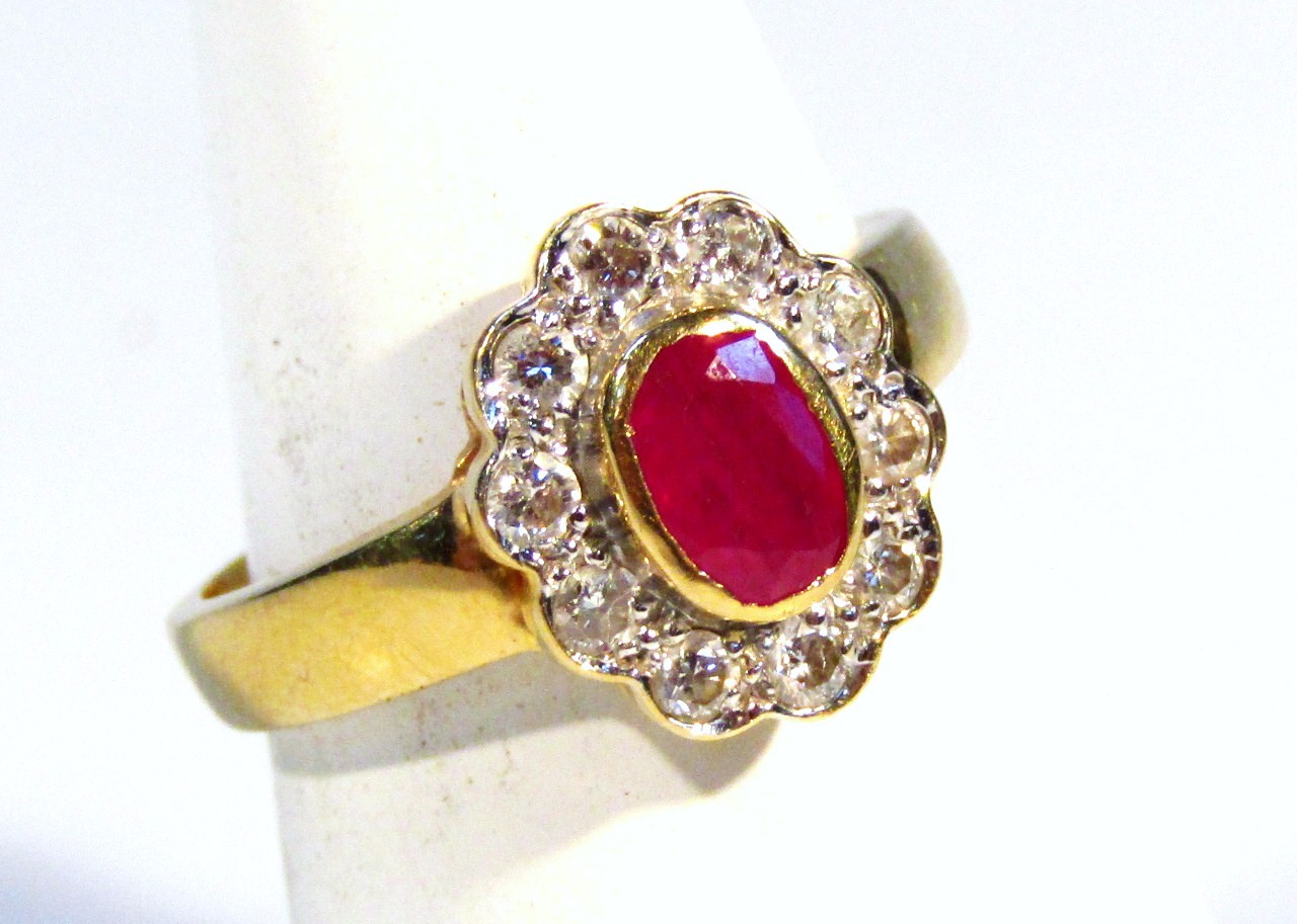 Appraisal: A ladies dress ring centred by an oval red stone