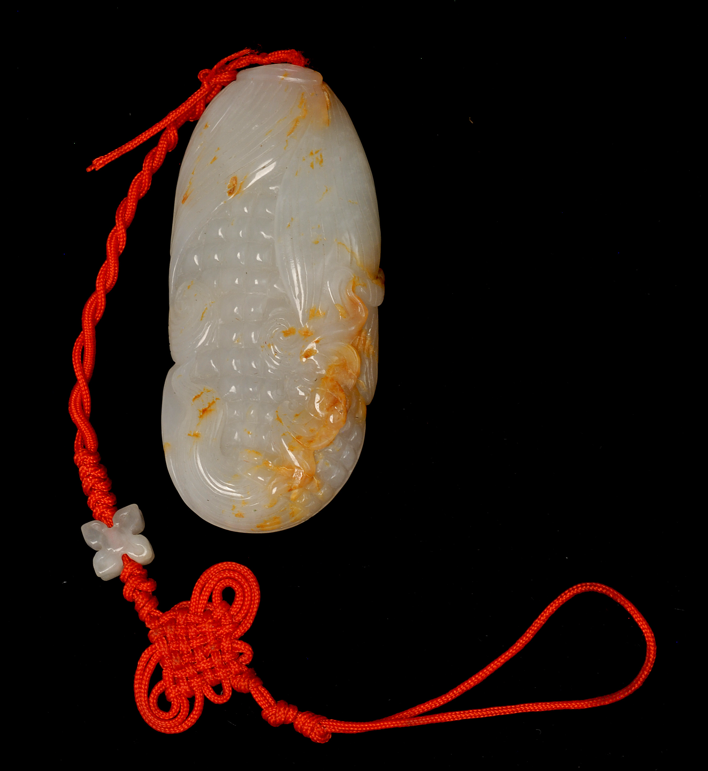 Appraisal: WHITE AND RUSSET JADE PENDANT In the form of an