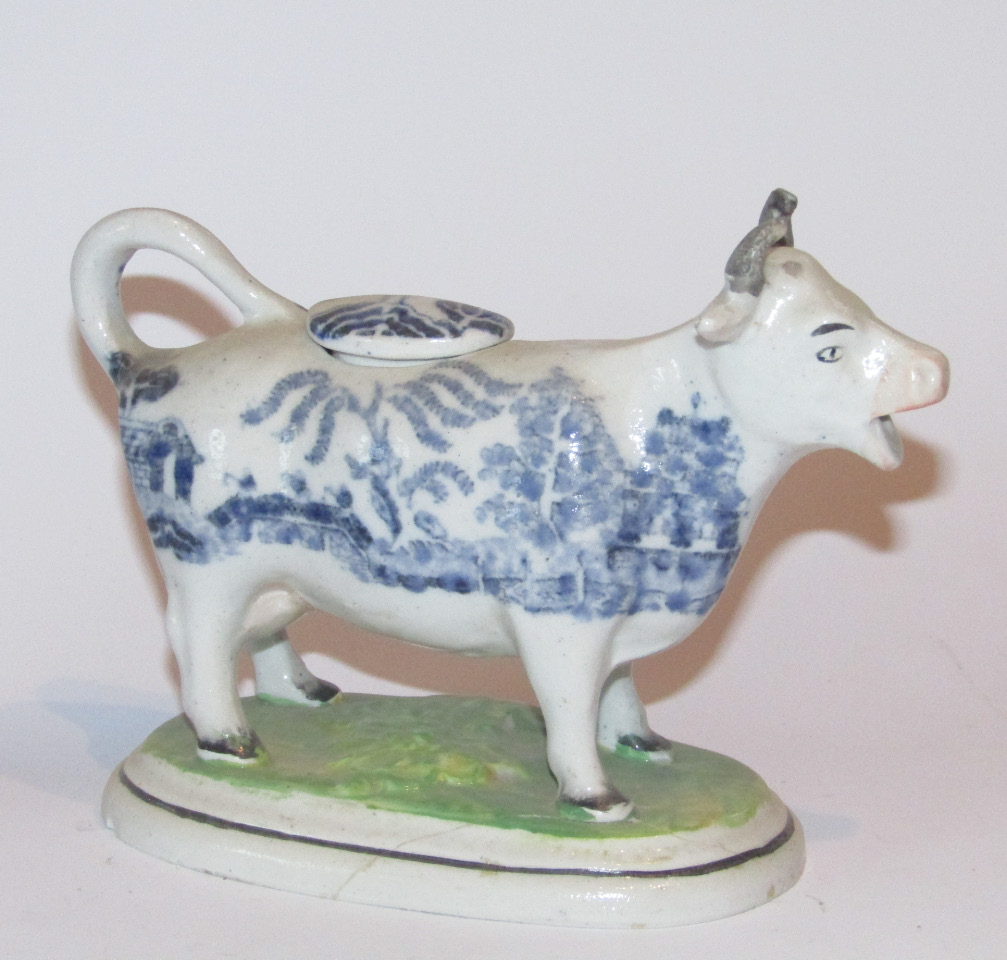 Appraisal: A thC Staffordshire blue and white cow creamer with tail