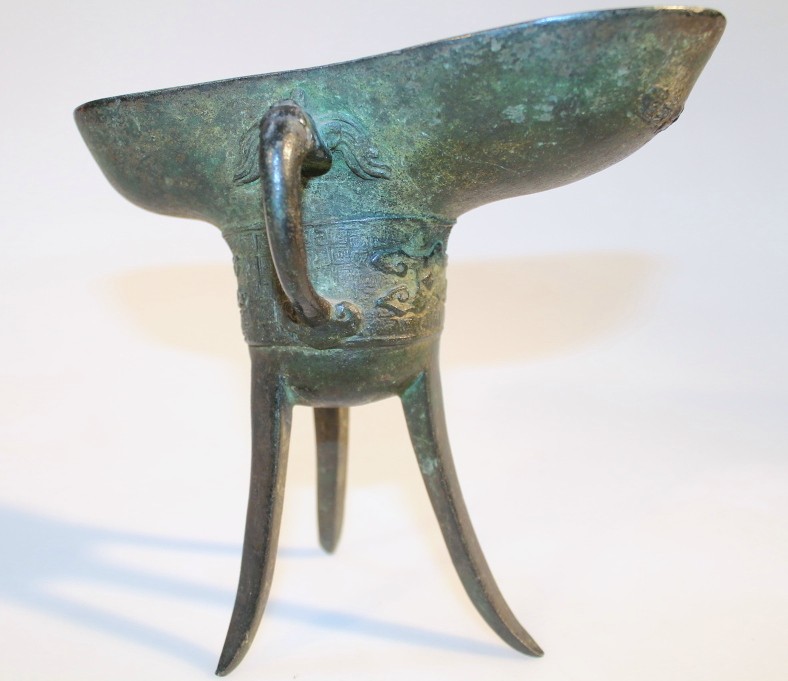 Appraisal: A Chinese bronze libation cup the shaped oblong top revealing