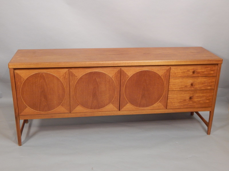 Appraisal: A Nathan teak Retro style low sideboard with an arrangement